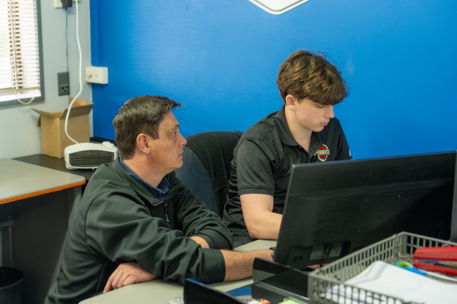 Senior technician and apprentice working through diagnostics together at the Turbo & Diesel workshop.